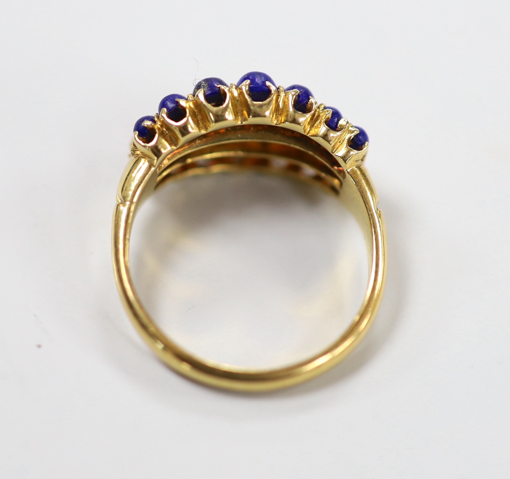 An early to mid 20th century yellow metal and graduated lapis lazuli, split pearl and coral set three row half hoop ring, size L, gross weight 4.3 grams.